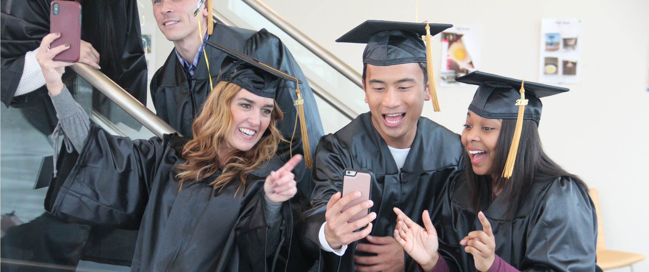 students on graduation day taking selfies