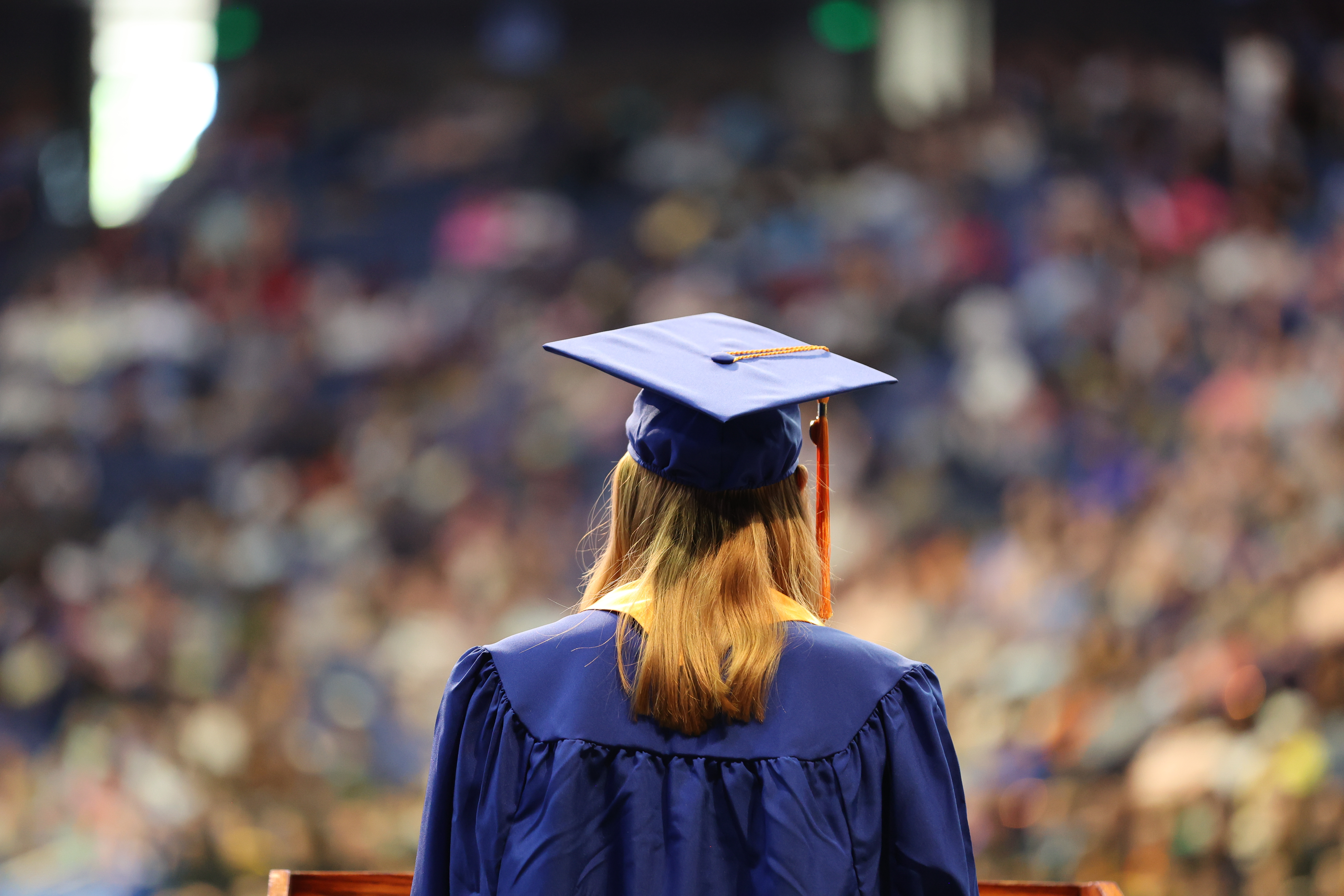 student in graduation robes at ceremony
