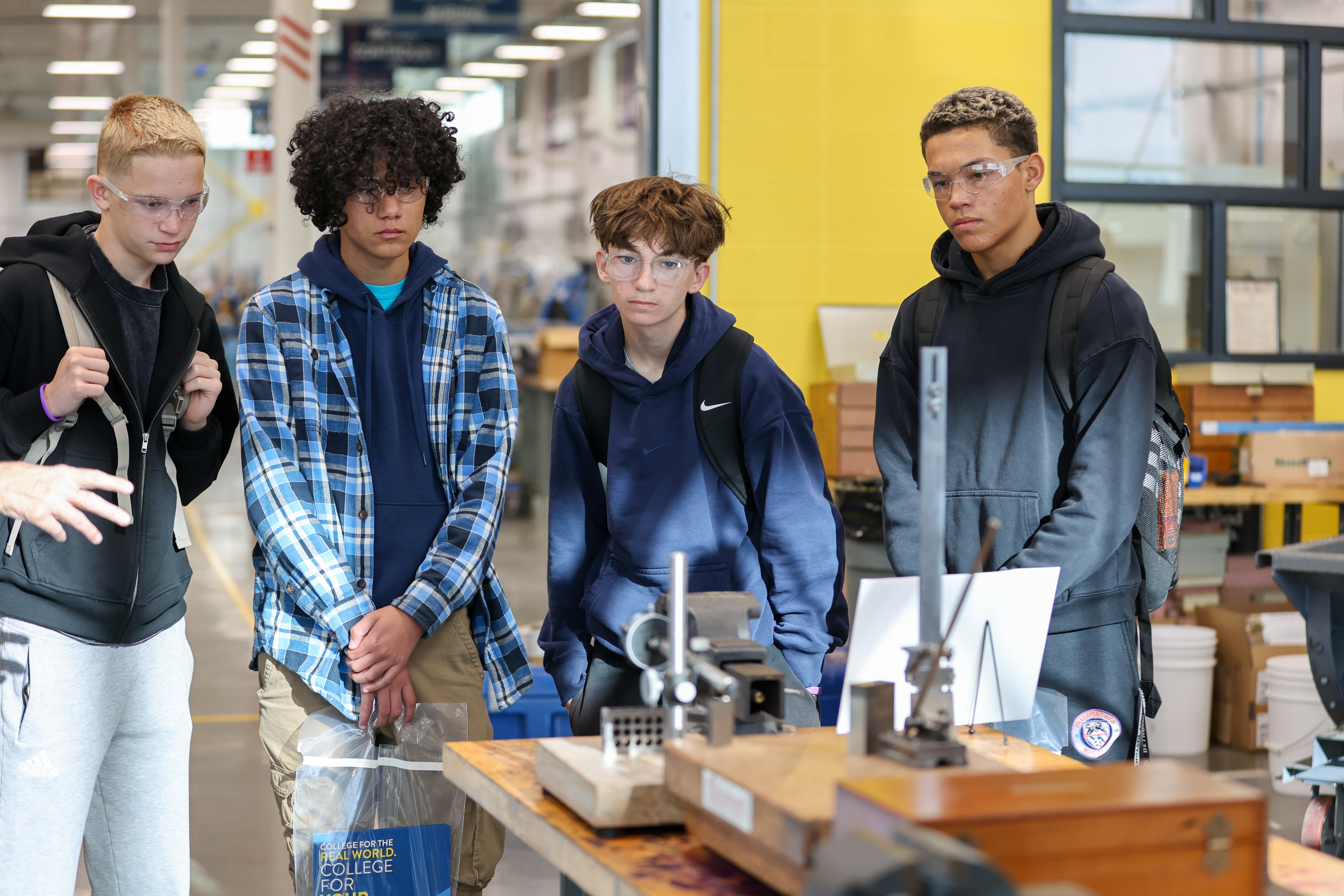 a group of students looking at lab equipment