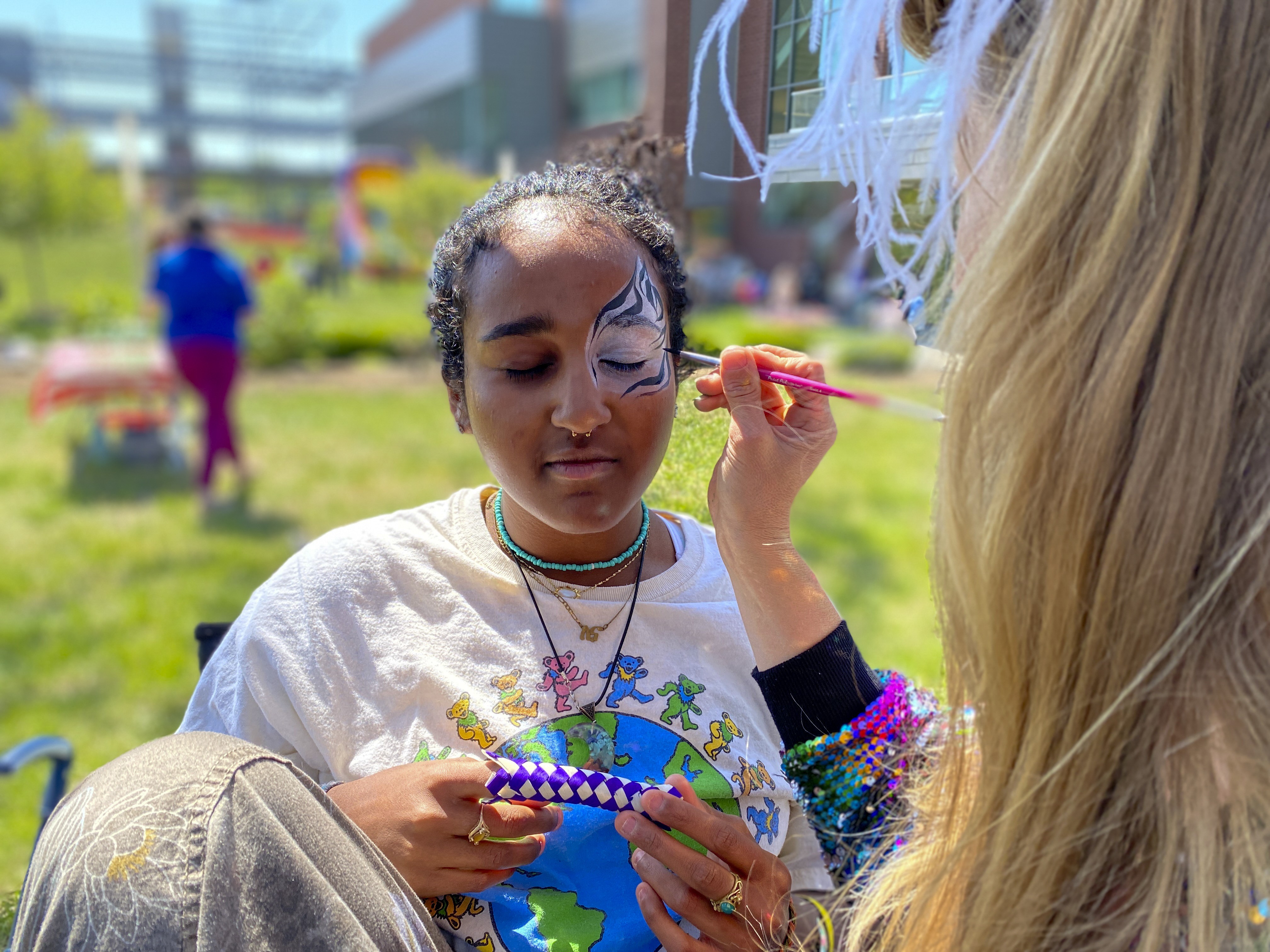 a student getting her face painted at an event