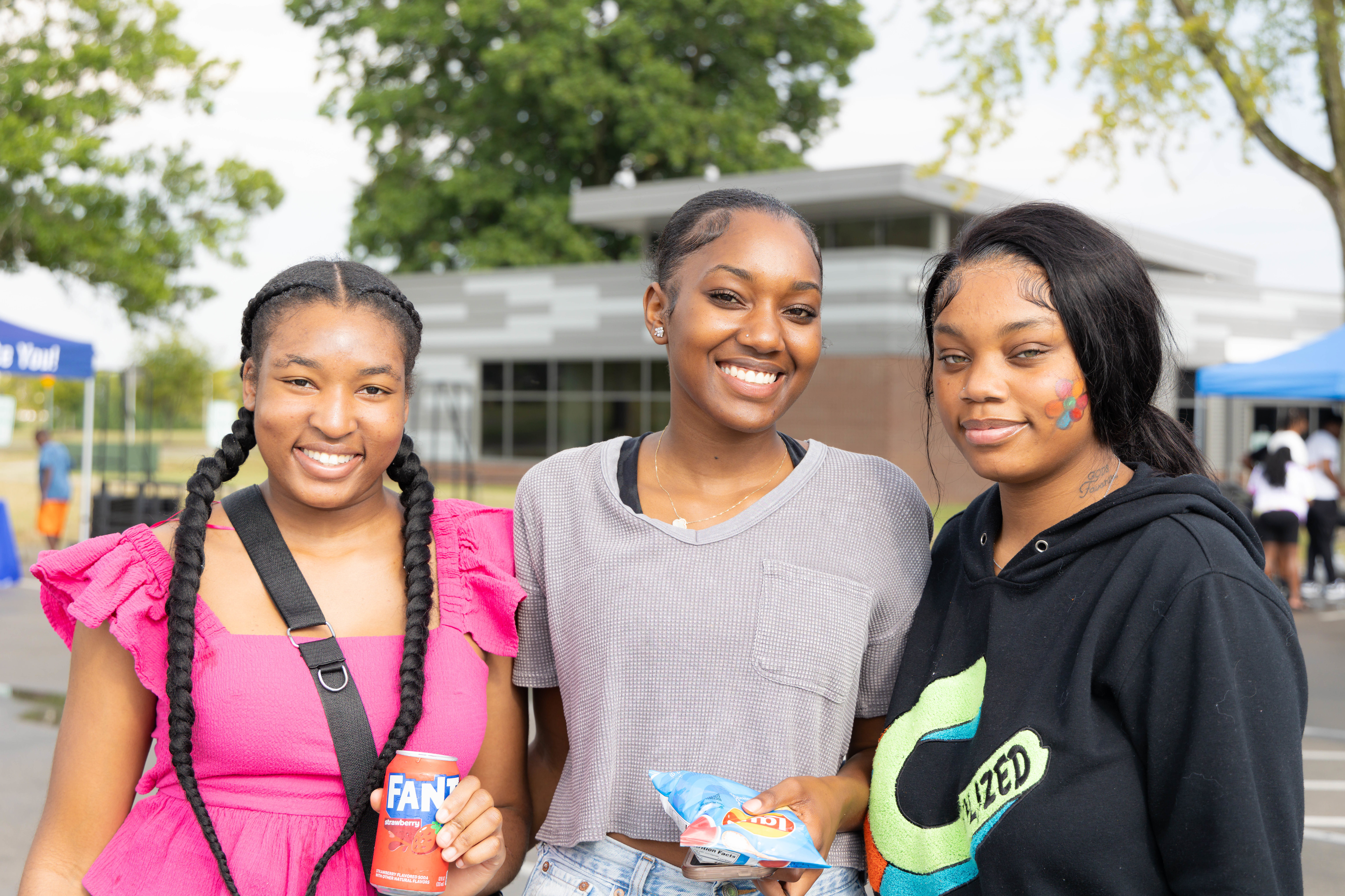three students smiling