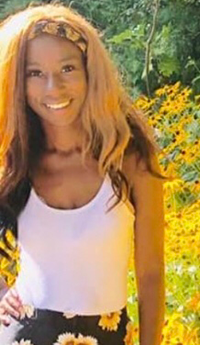 Jaleeyah Mullen standing in a field of sunflowers