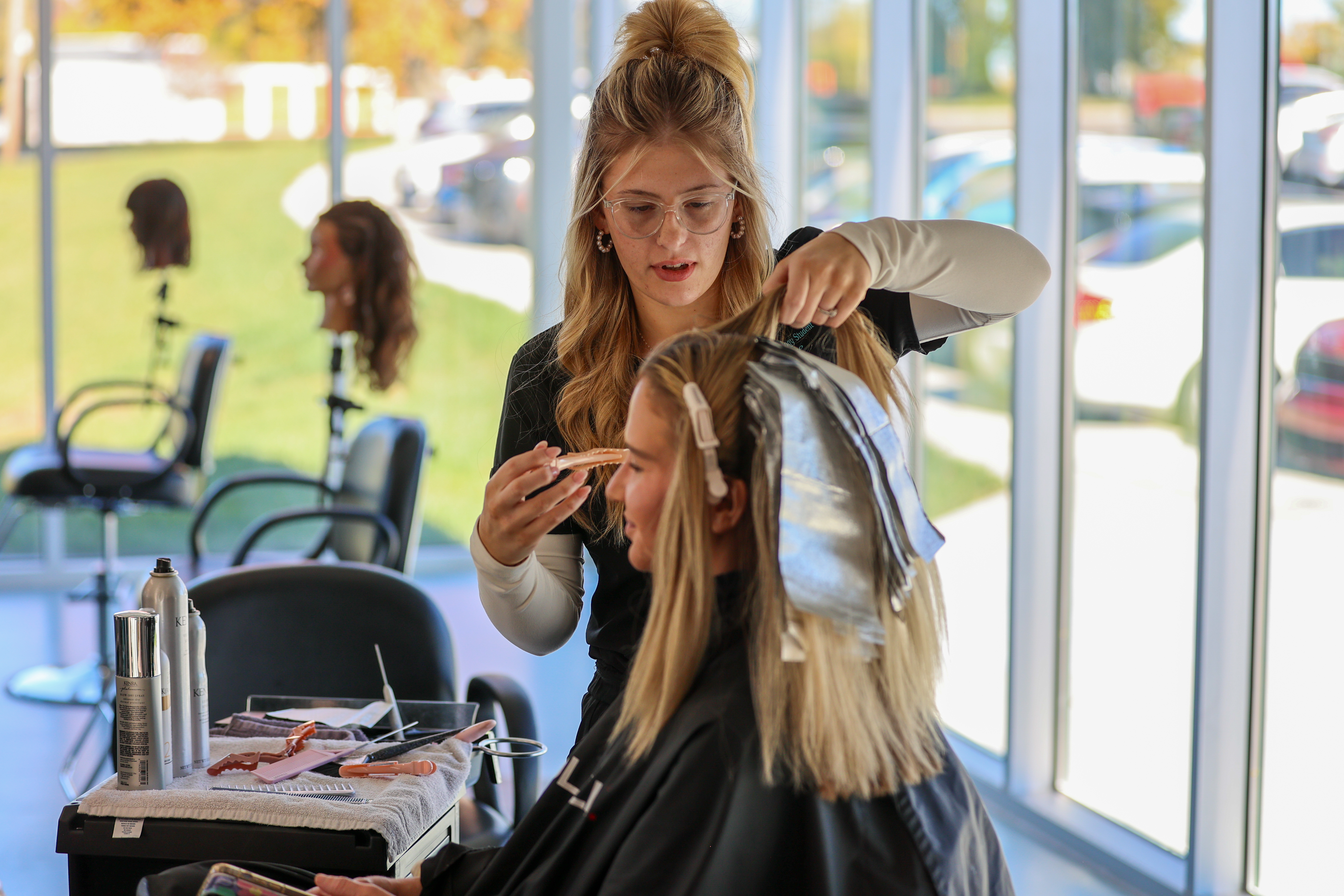 cosmetology student with client