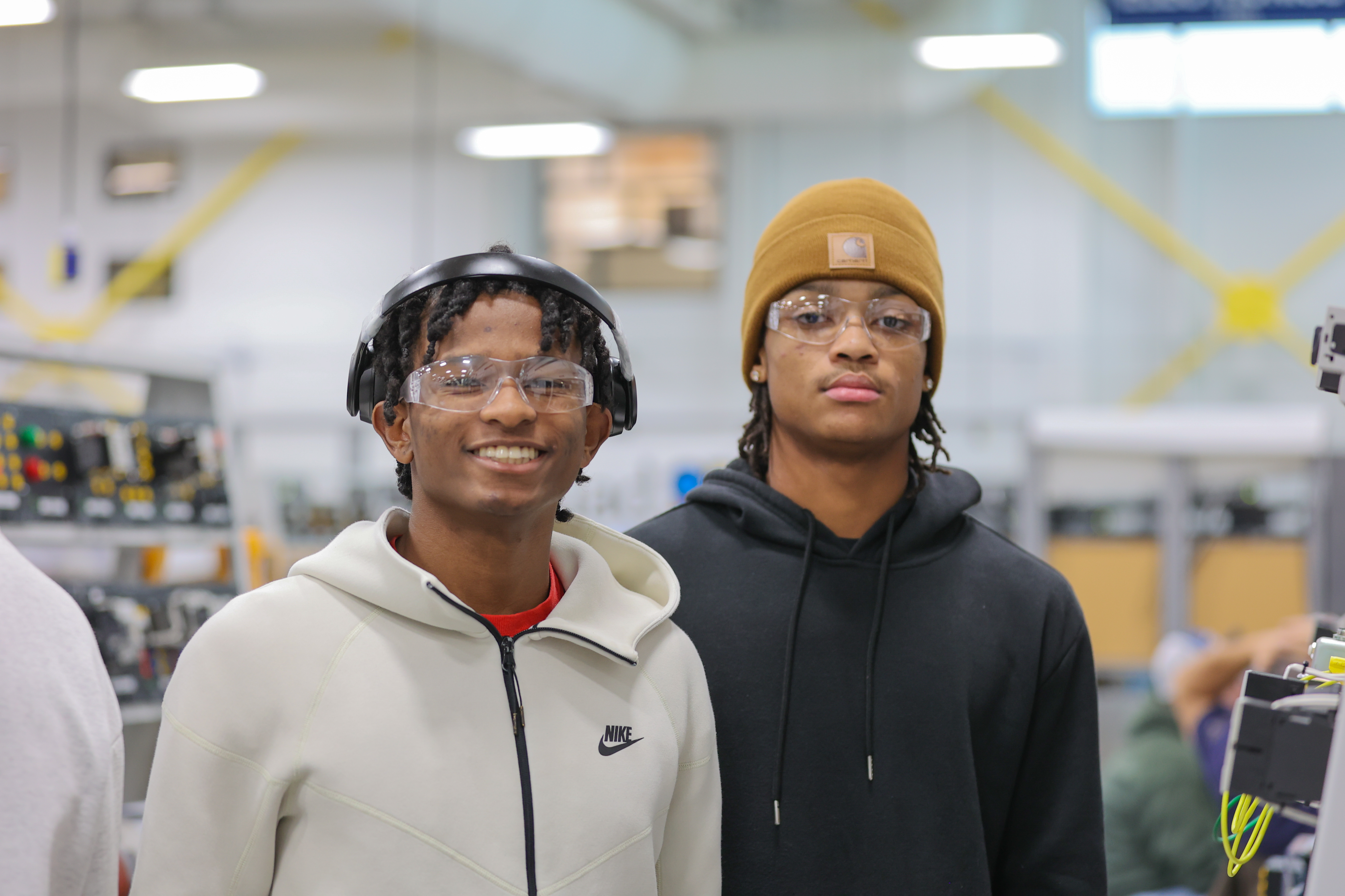 two students stand together in lab