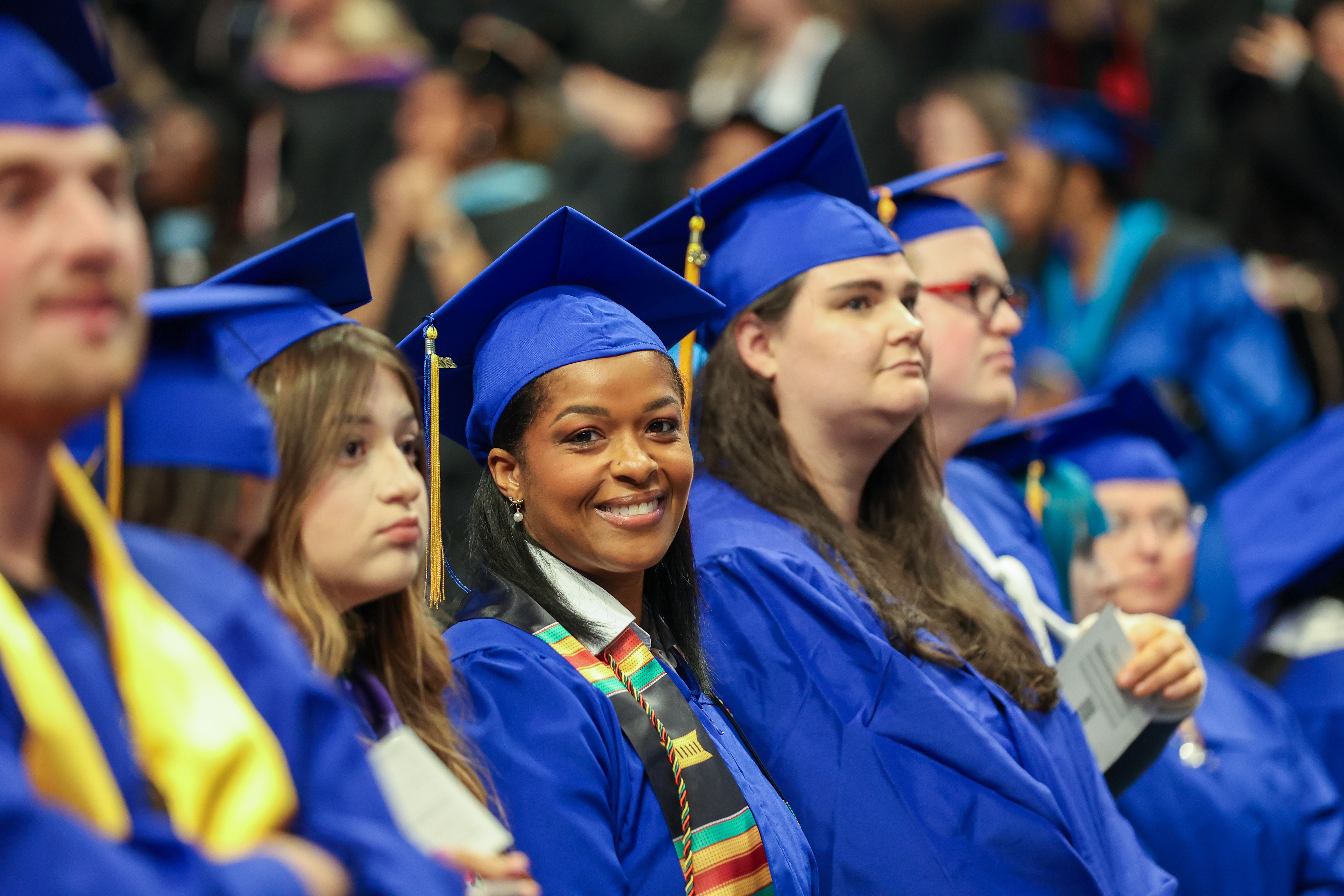 an adult graduate smiling
