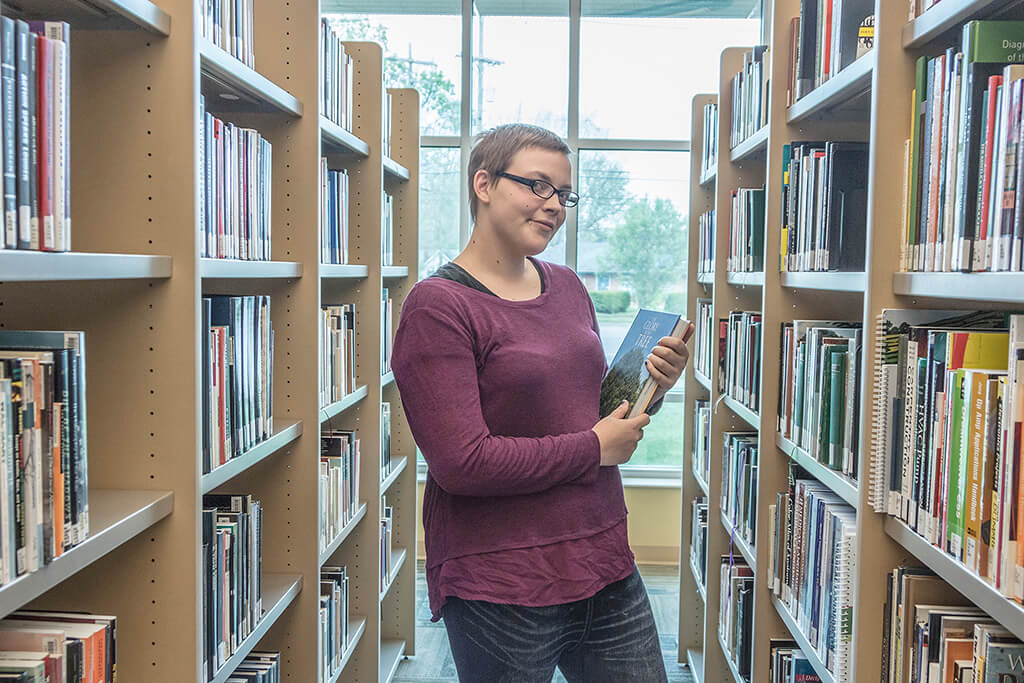 girl with book in library