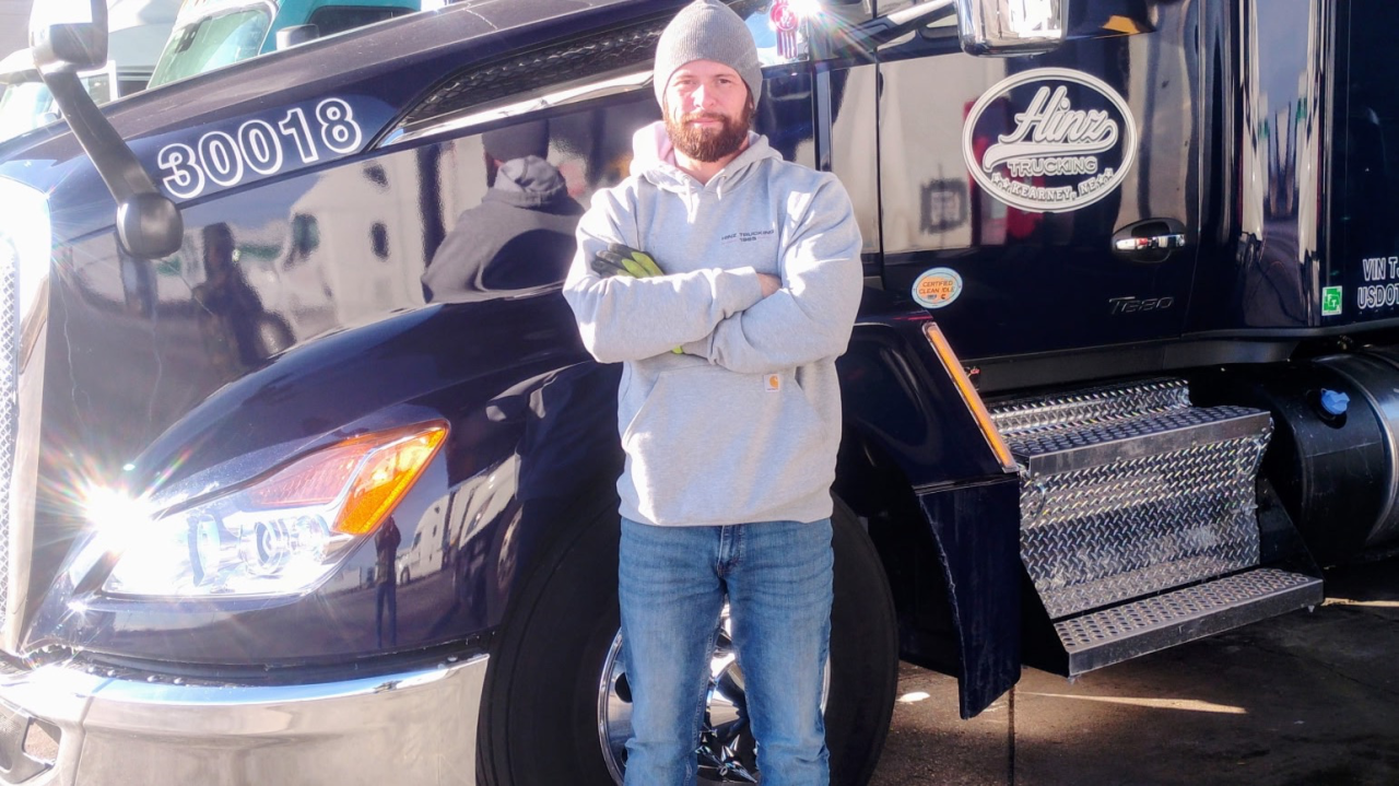 a man standing next to a commercial truck