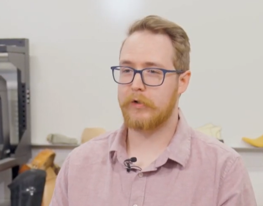 Person wearing glasses sitting and talking