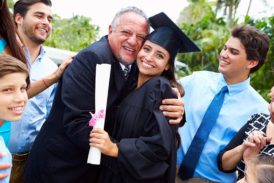 graduate with family and friends