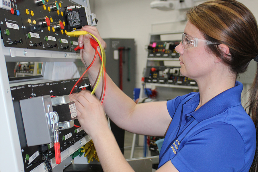 person in front of mechanical switchboard