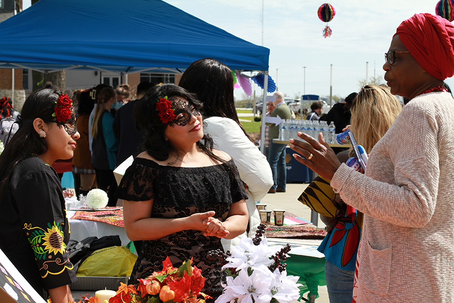 people in traditional-style dresses at BCTC event booth