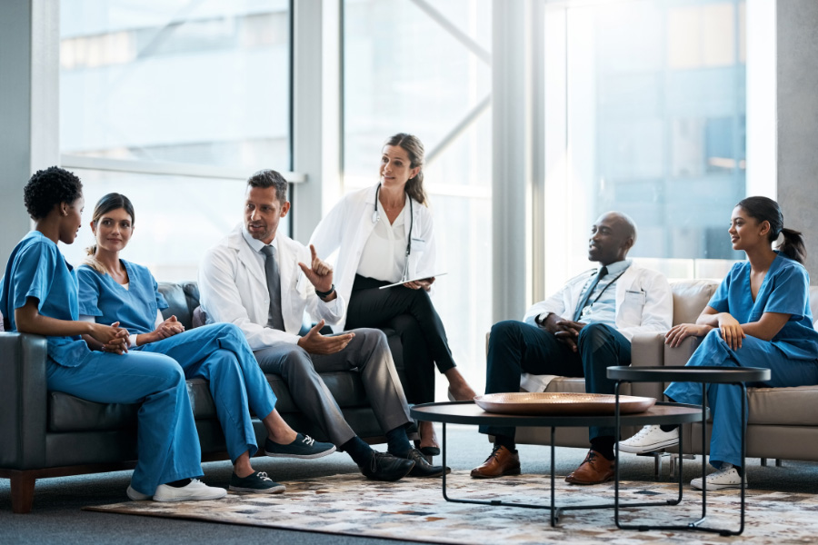 doctors and nurses sitting together on couches