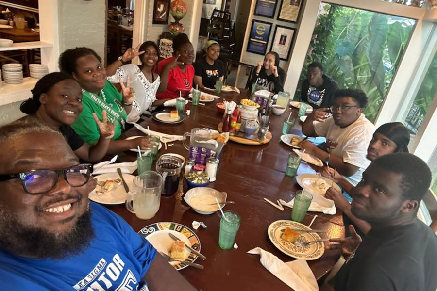 Bridge to Success Summer Program participants at group meal with Kauai Thurman and Dr. Carlous Yates