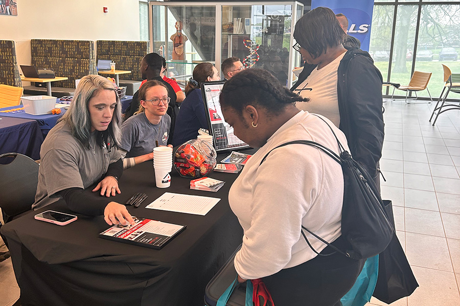 Students stopping at Career Services table during Career Fair