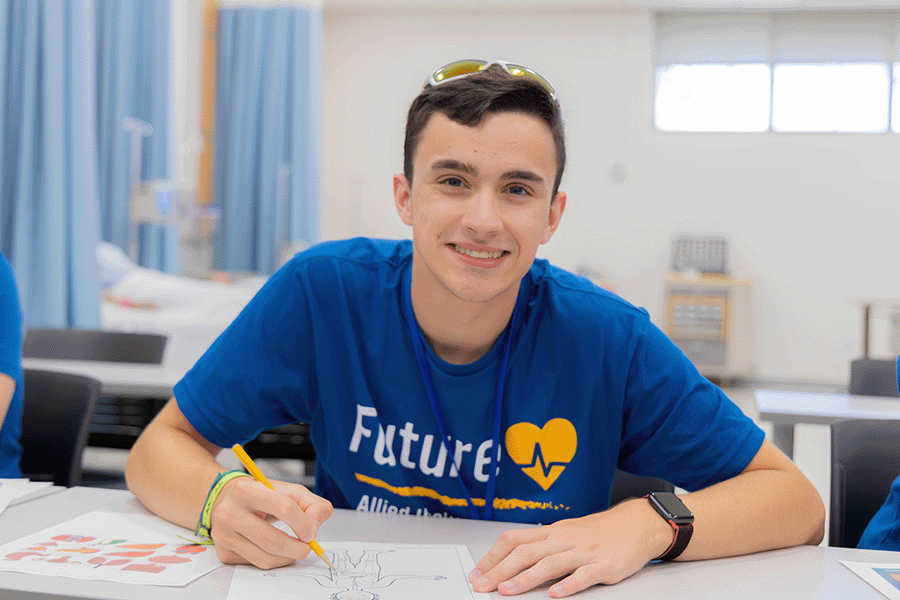 healthcare student at a table working on medical worksheet