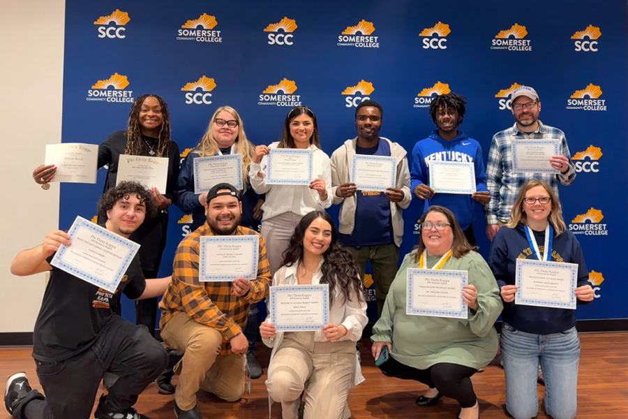 BCTC PTK members holding award certificates