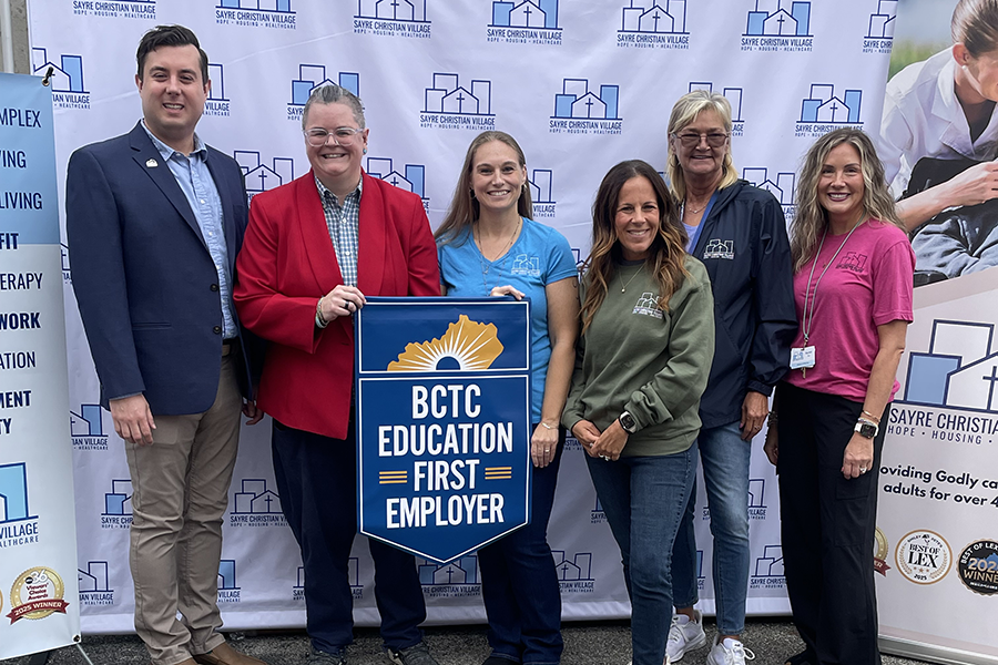 BCTC staff and Sayre Christian Village representatives holding