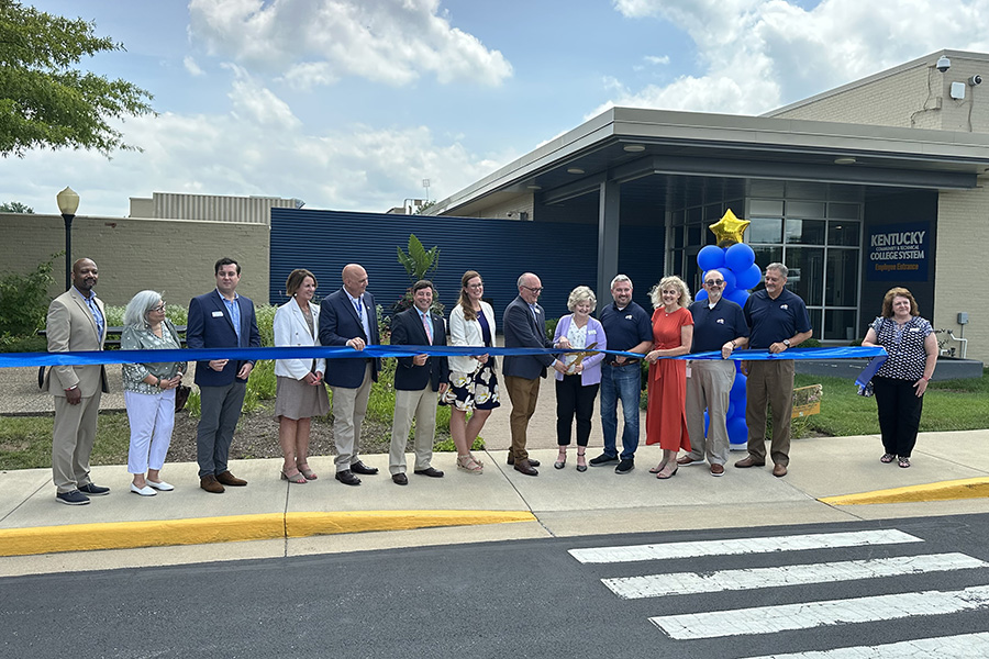 Dr. Feeney cutting ribbon in front of KCTCS