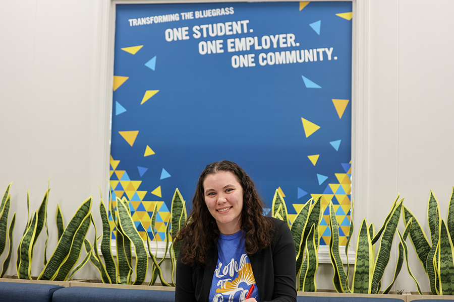 person standing in front of blue board with yellow and gold designs