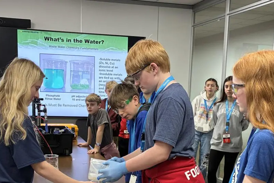 students in safety equipment doing lab activity