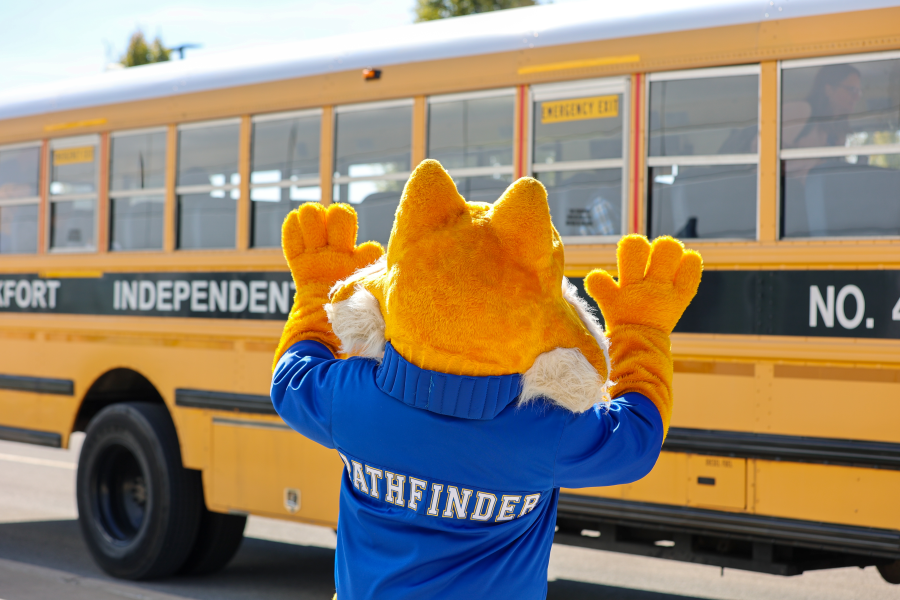 pathfinder mascot waving at a school bus