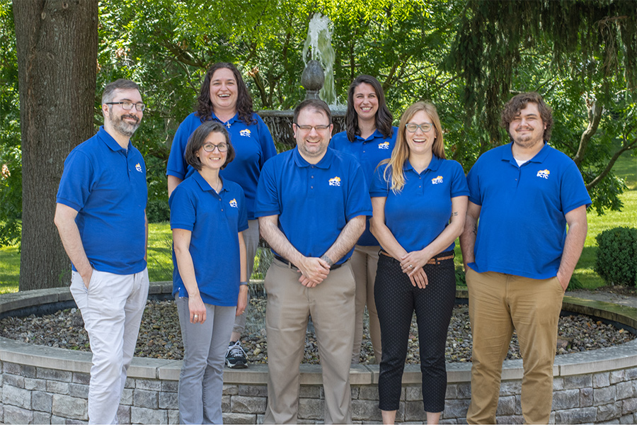 Student Success Hub staff standing in a group in front of a fountain
