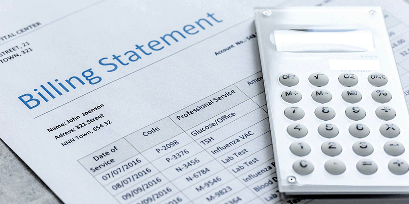 medical lab billing statement with calculator sitting on top